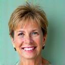 Smiling woman in her 40s, Elizabeth, looking vibrant and healthy, symbolizing a wellness success story.